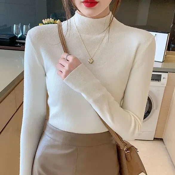 Women's slim fit viscose knitted long sleeve pullover top in apricot colour.