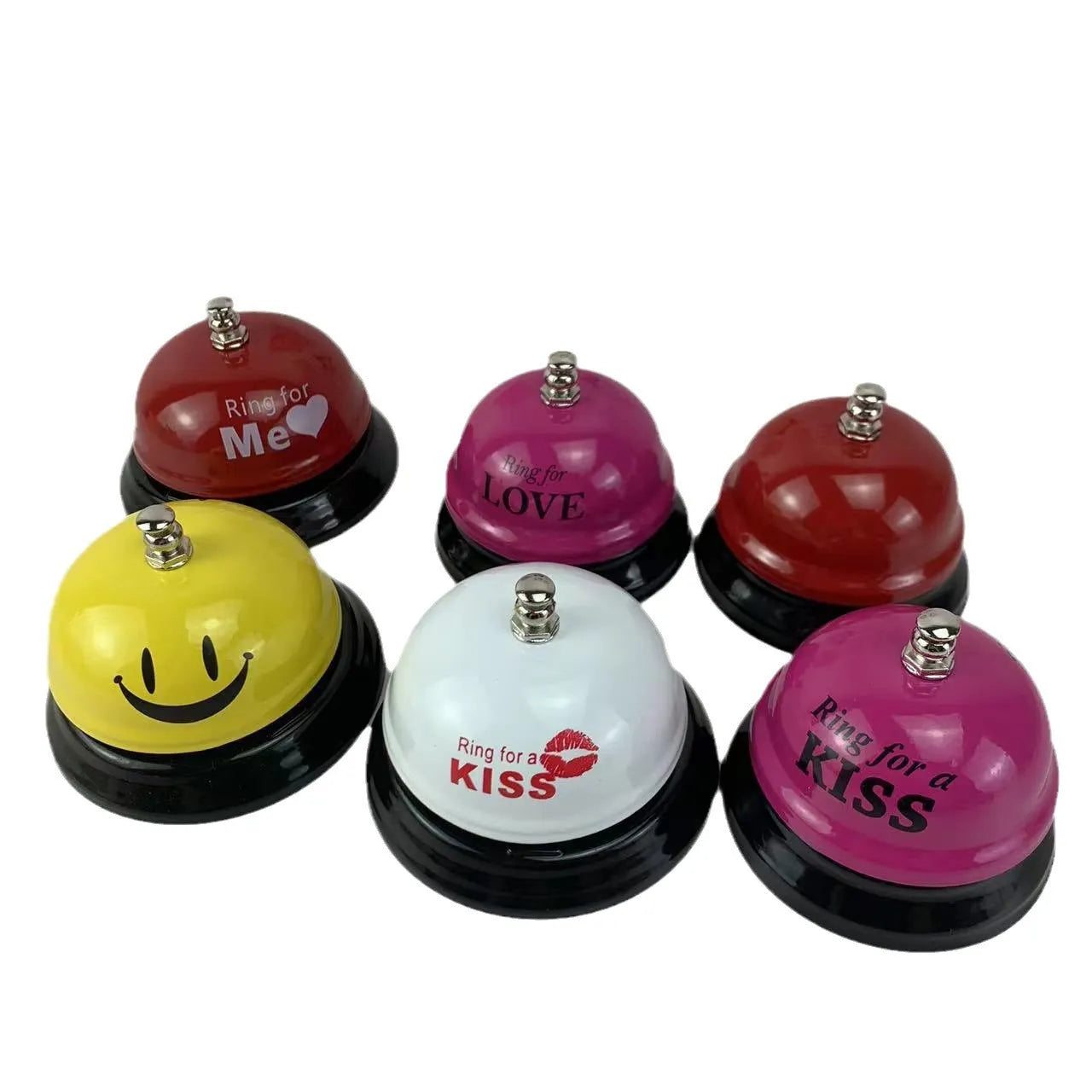 Iron table serving bell in multiple colour options on a wooden surface.