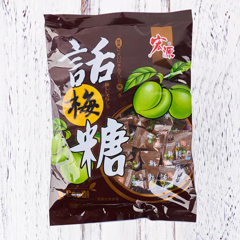 Three bags of Asian fruit hard candy: plum sugar, guava, and tangerine peel varieties with weight labels