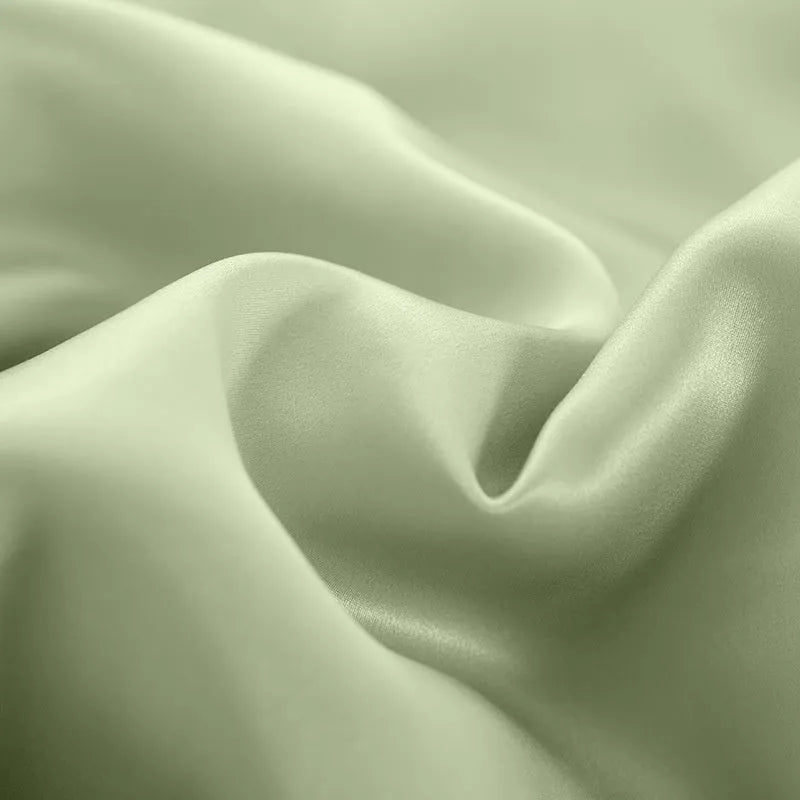 Double-sided solid colour silk duvet cover in bright brown laid flat on a bed.