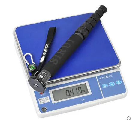 Black carbon fibre SLR camera monopod fully extended, showing its 6-section telescopic design.