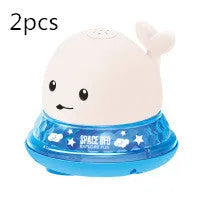 Whale-shaped baby bath toy with automatic water spray and colourful lights floating in water.