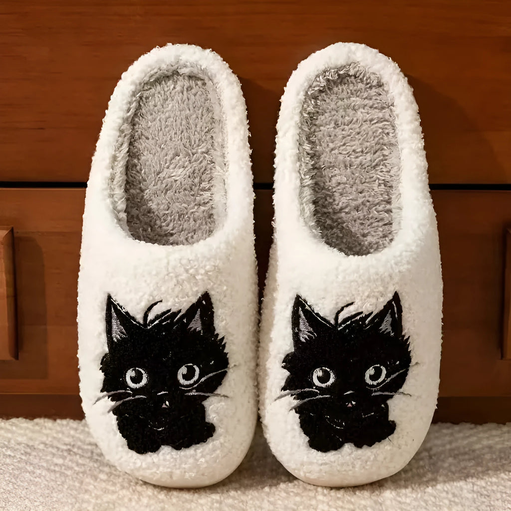 White plush couple slippers with black beard cat cartoon design and non-slip soles.