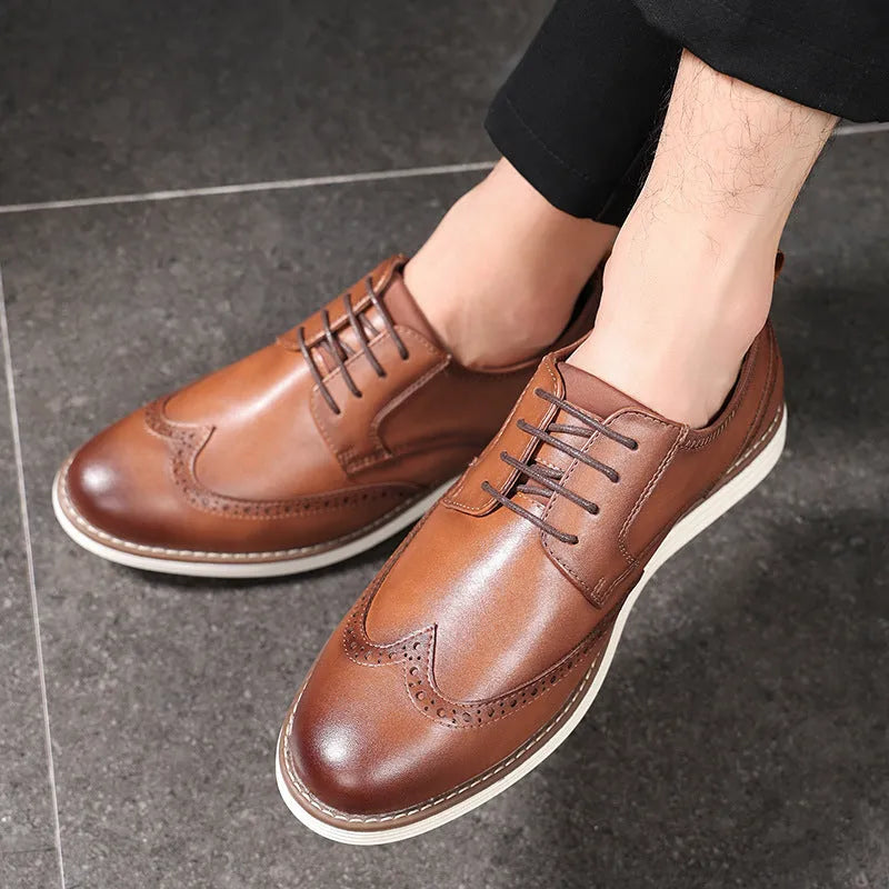 Men's black and brown slip-on casual shoes with round toe and carved detail on the upper.