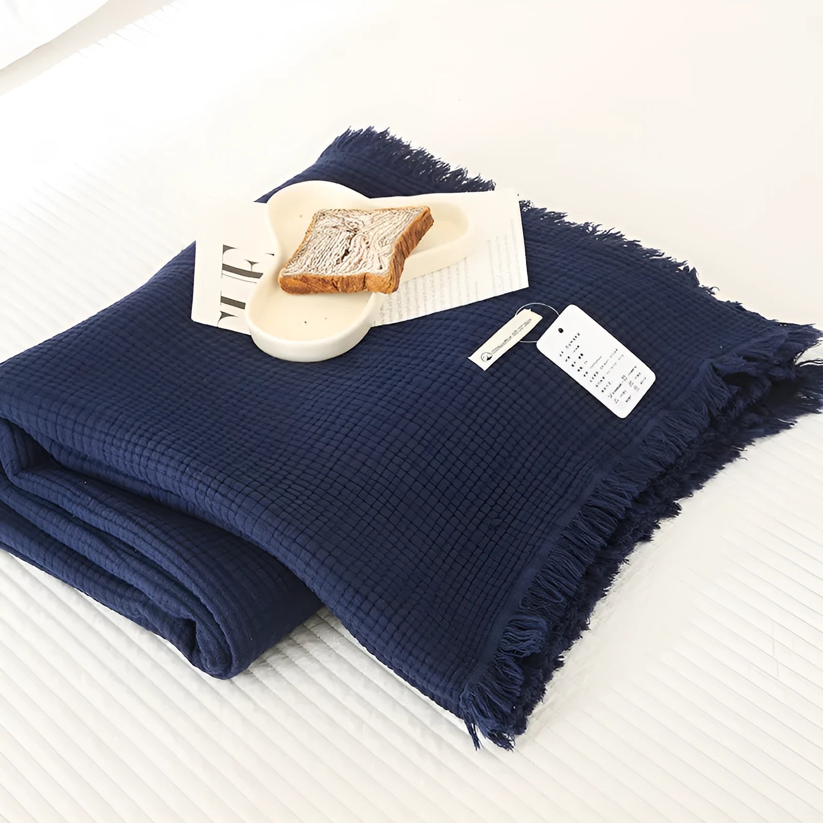 Four-layer gauze cotton blanket with tassel trim in a choice of ten colours and two sizes.