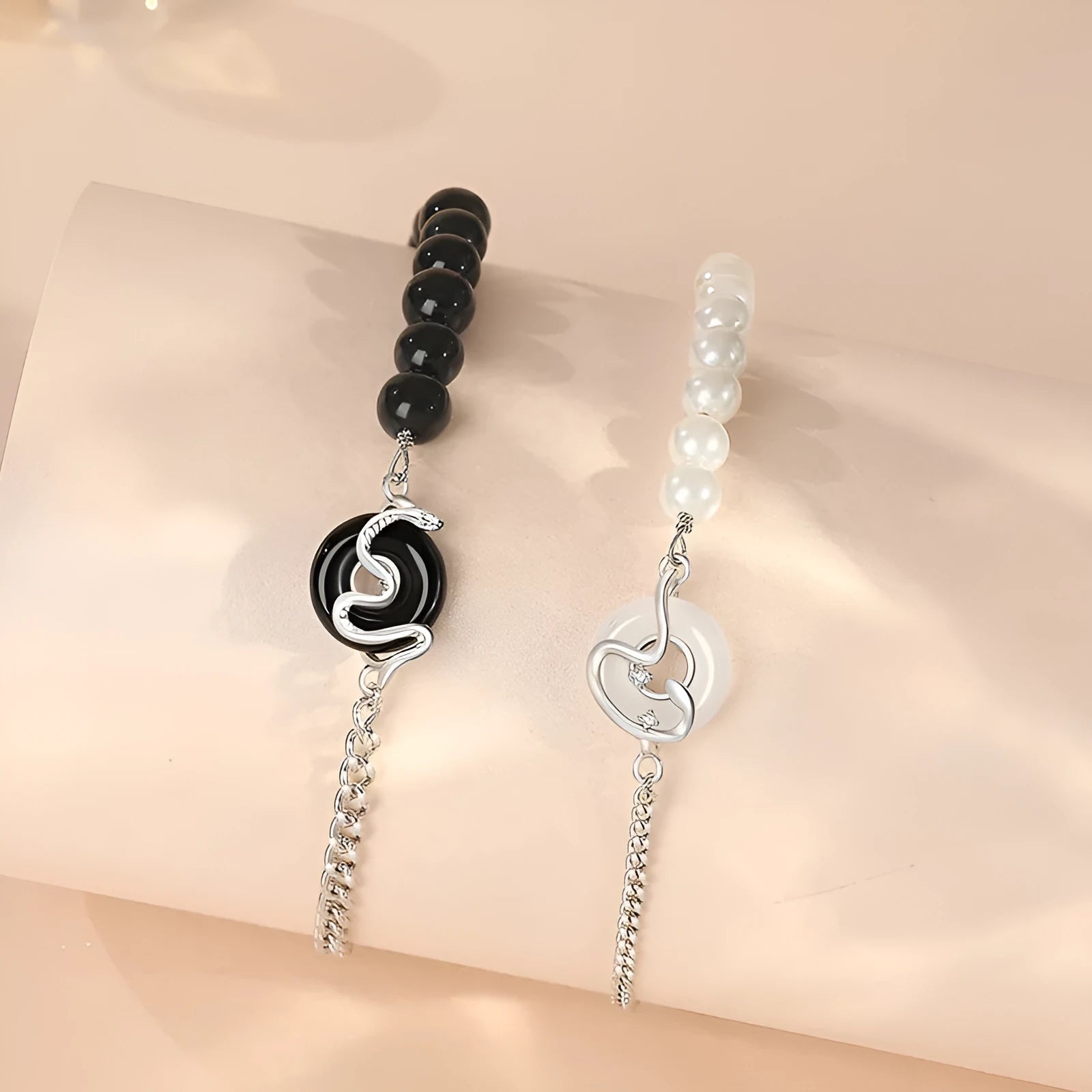 925 sterling silver couple bracelet with safe buckle, snake zodiac design, and obsidian pearl details in New Chinese style.