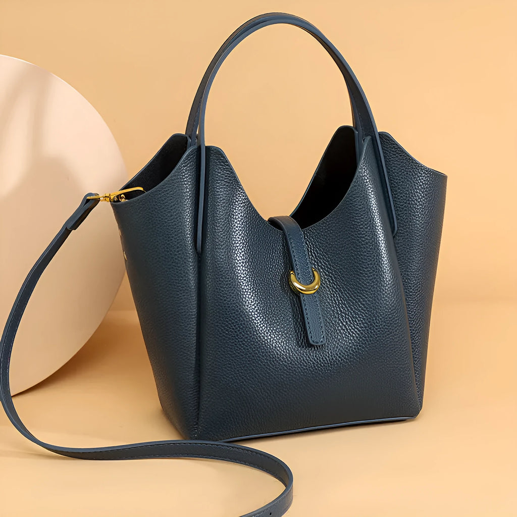 Genuine leather retro bucket handbag for women in beige, showing sewn thread detail and handheld straps.