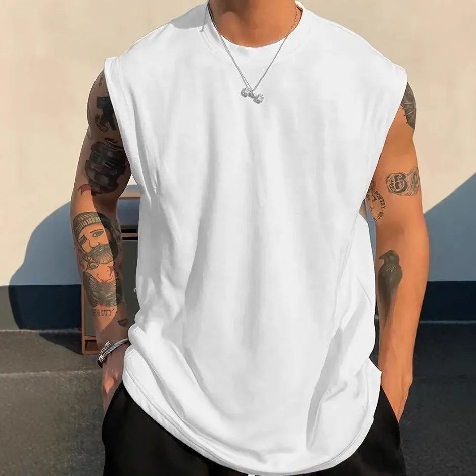 Men's loose fit solid colour cotton tank top shown in a selection of available colours and sizes.