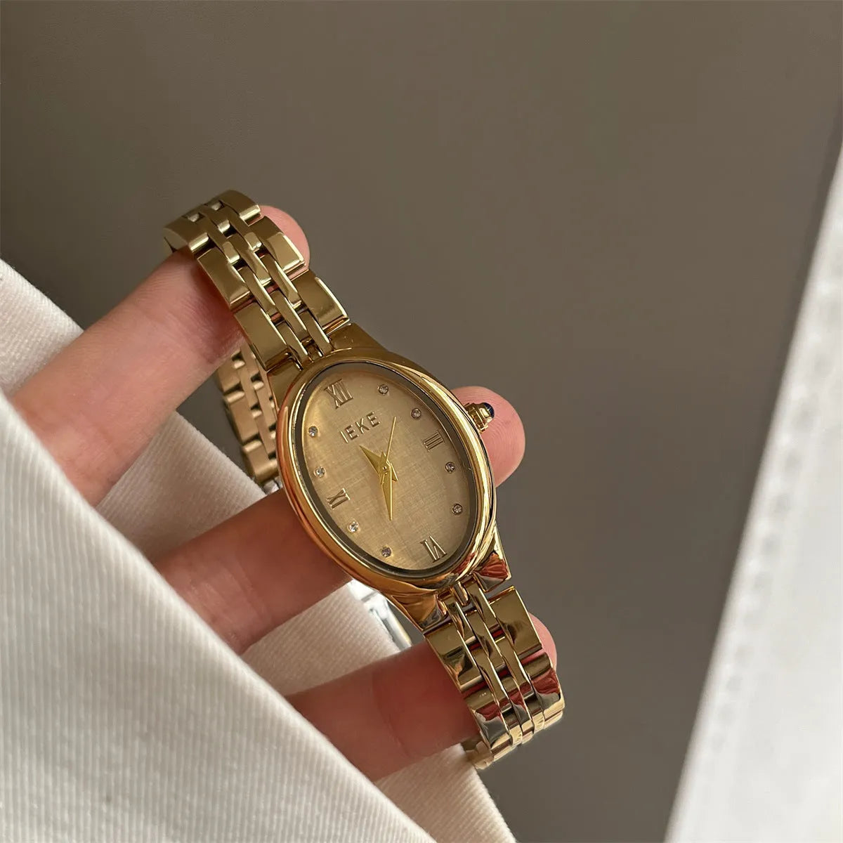 Oval dial ladies watch with dot markers, 37mm, gold strap and gold face