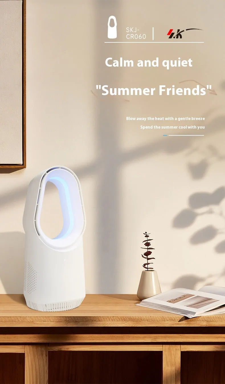 White bladeless tower fan with remote control on a wooden floor next to a desk.