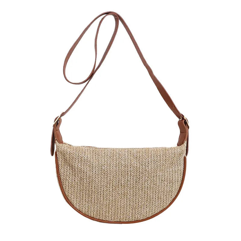 Women's straw woven crossbody bag showing woven texture and internal phone pocket