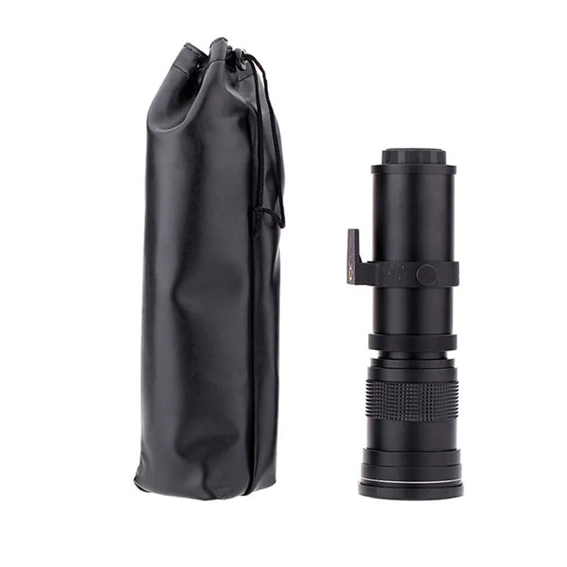 420-800mm manual telephoto zoom camera lens with T-port adapter ring on a table