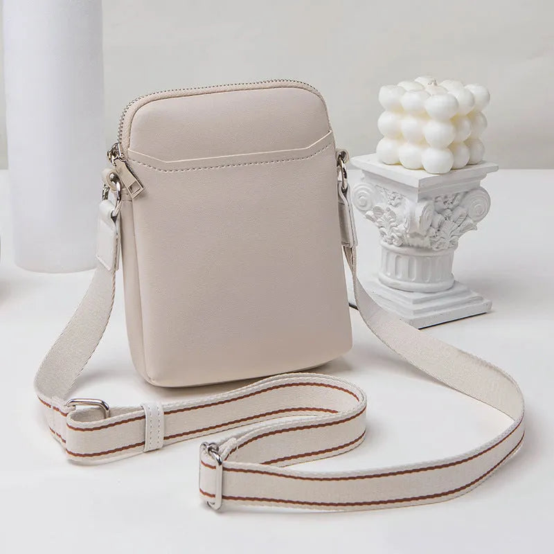 Small solid colour crossbody phone bag for women in beige.