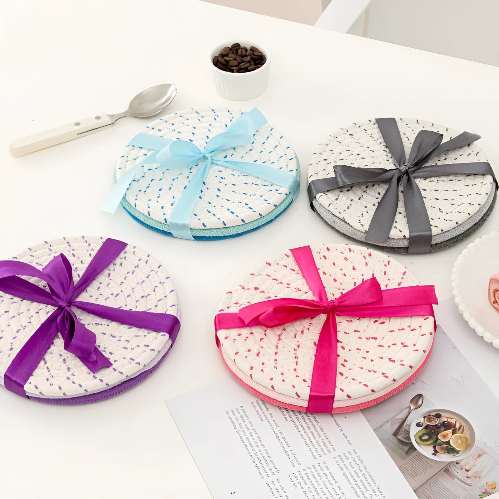 Set of three round cotton cord coasters in a choice of colours on a wooden table