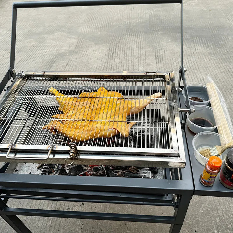 Large foldable charcoal BBQ stove set up in a garden.