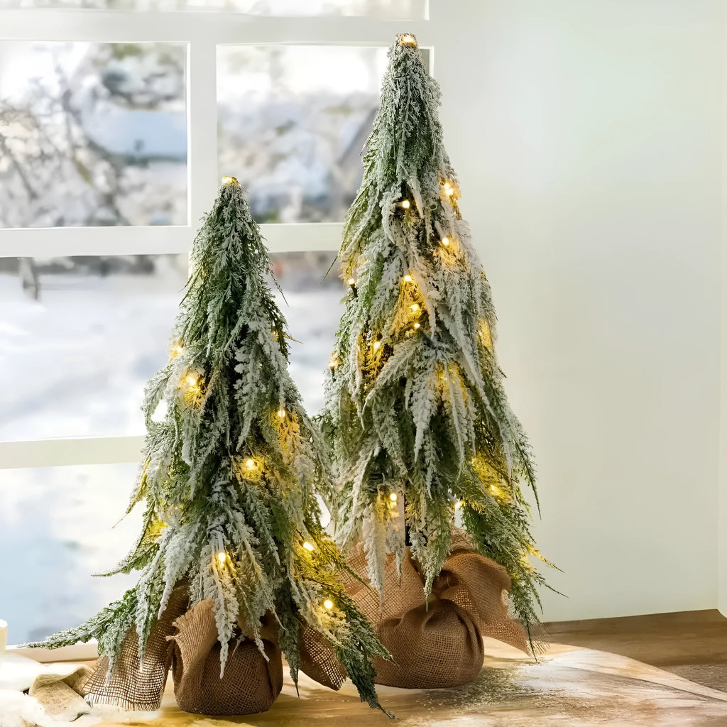 24-inch plastic artificial Christmas tree with snow sprayer and integrated lights on desktop