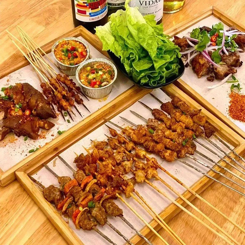 Square bamboo serving tray with brown handle on solid colour surface