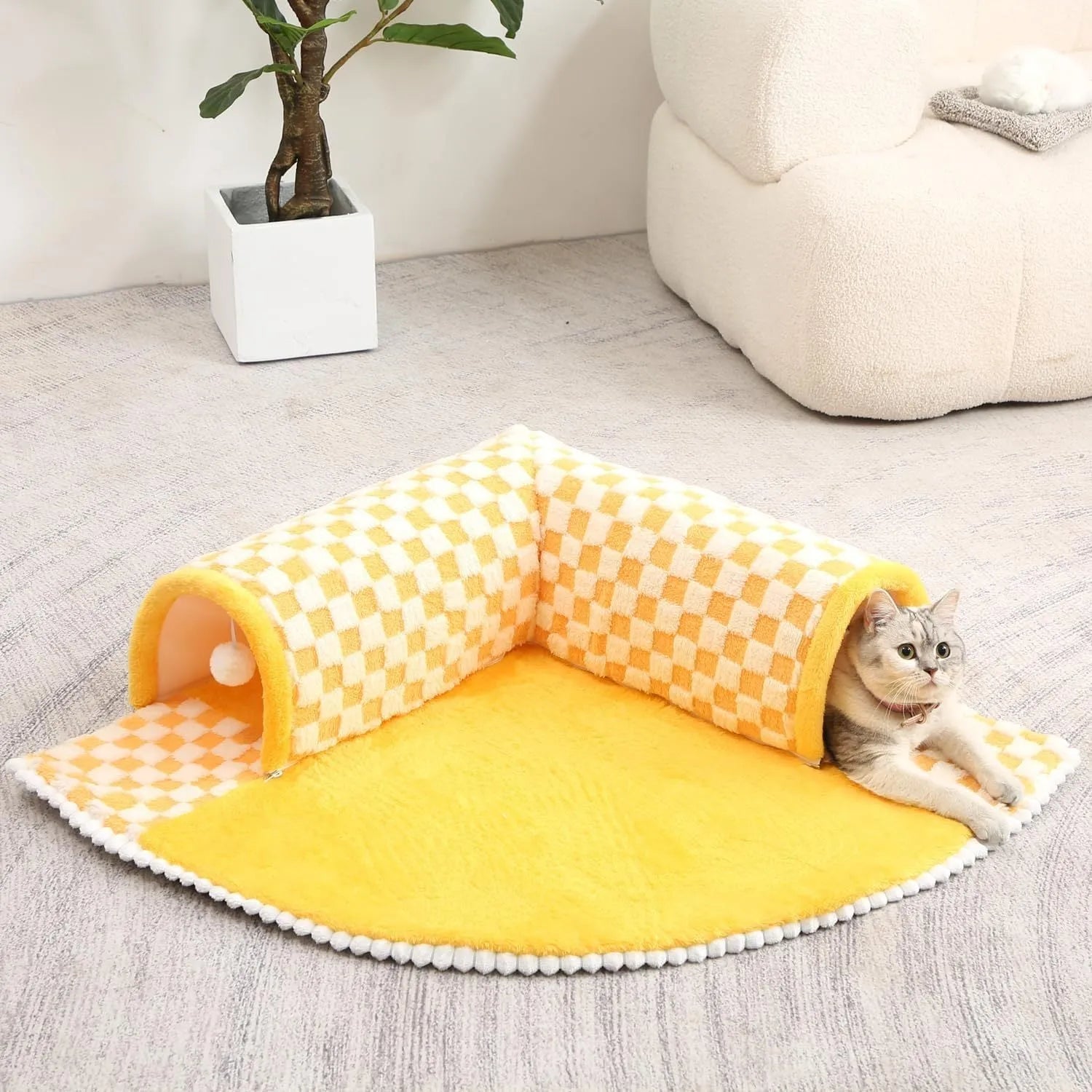 Large fan-shaped plush pet bed with attached tunnel in coffee colour on a wooden floor