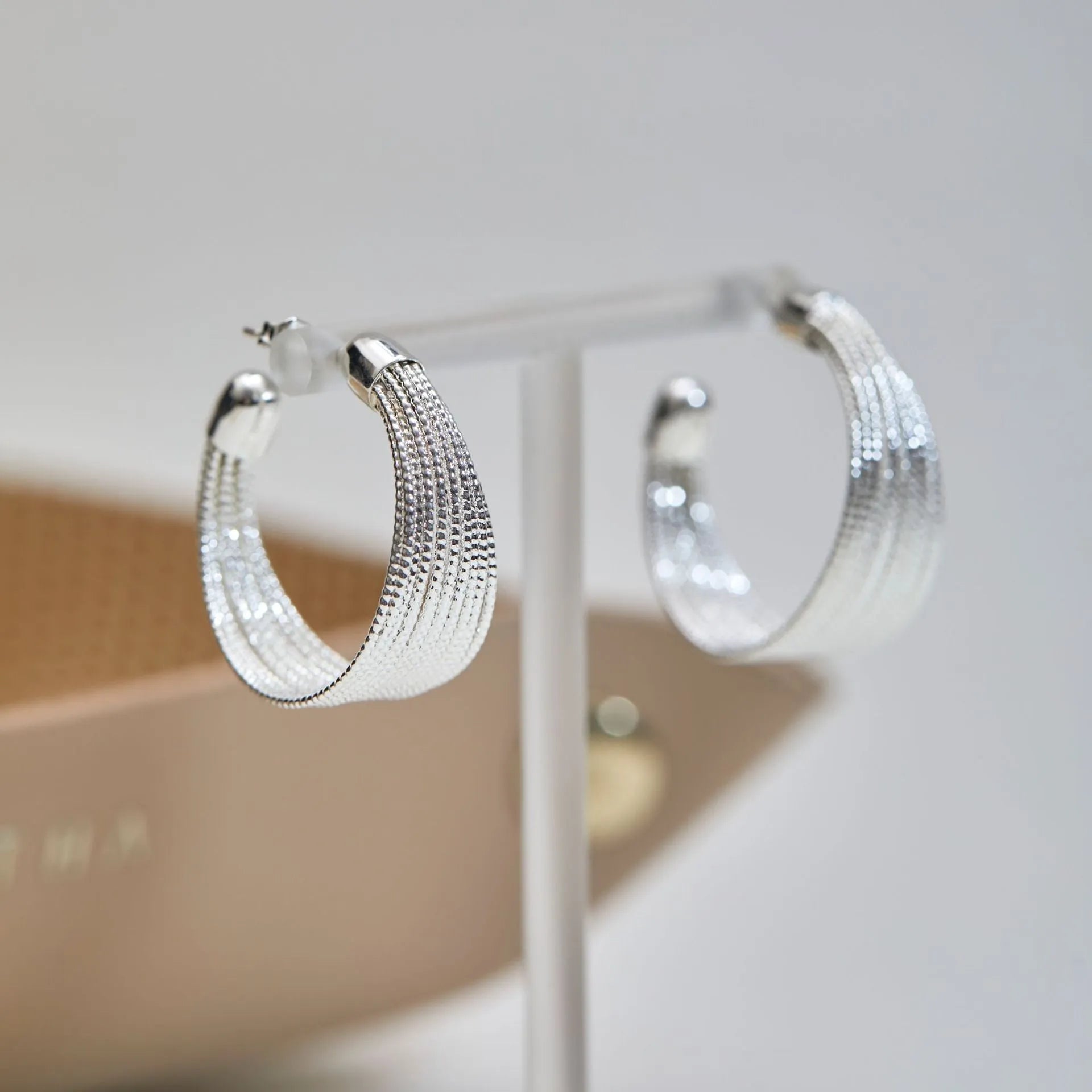 Simple geometric bracelet earrings with clip and stud backs in silver or gold colour.