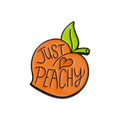 Colourful cartoon fruit design zinc alloy brooch pin on a fabric background.