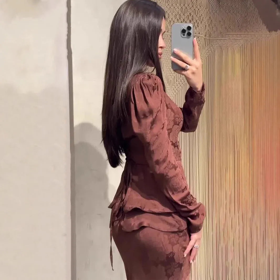 Women's dark brown artistic retro dress with plant pattern and button detailing showing long sleeves and fake two-piece styling