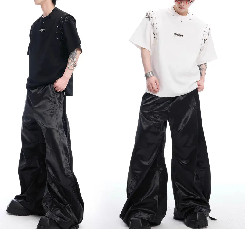 Women's black deconstruction short sleeve t-shirt with a white lace-up detail and front cutout.