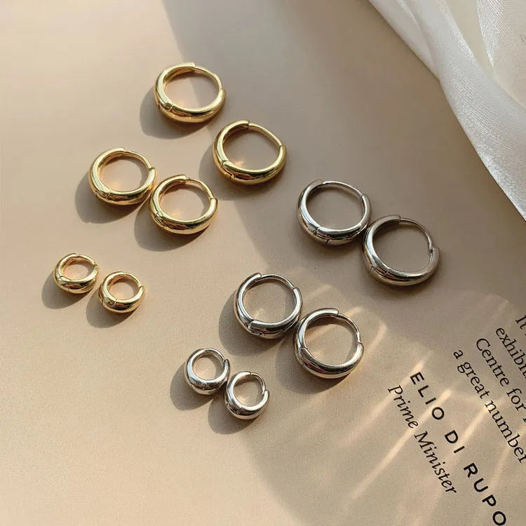 Women's minimalist geometric water drop earrings in gold or silver finish, showing three size variations