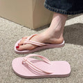 Men's PVC toe-covering flip flops in beige colour on a plain background.