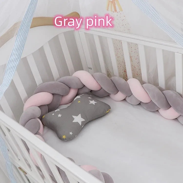 Braided knot pillow cushion bumper for infant crib in spandex velvet, shown in a light colour.