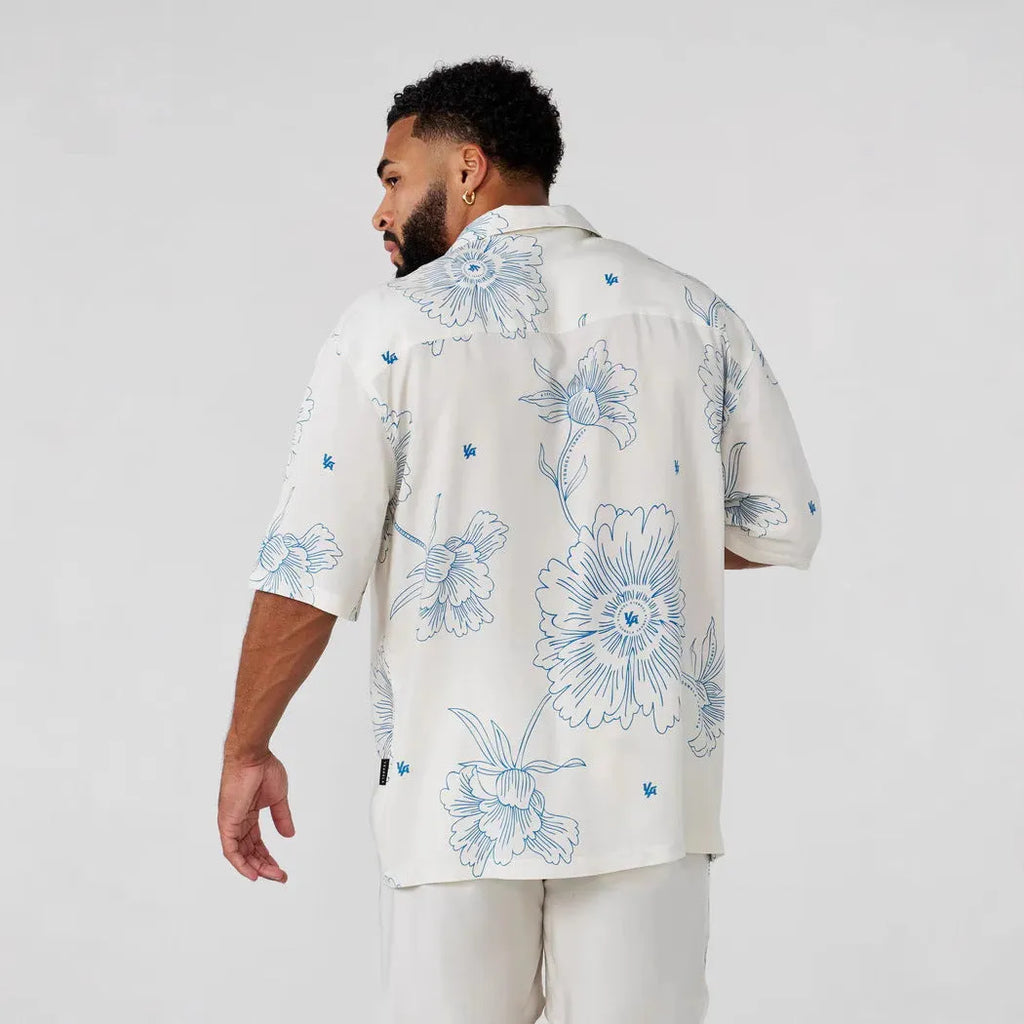 Men's loose floral print short-sleeve casual top in light colour on hanger