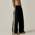 Black men's wide-leg high-waist climbing trousers laid flat, showing straight cut and polyester fabric.