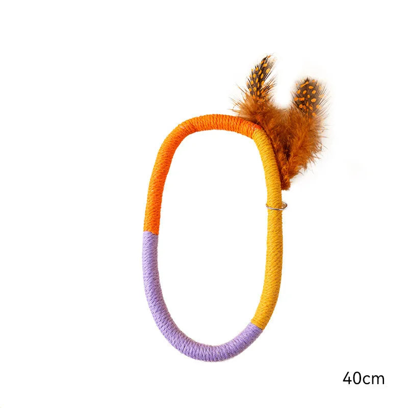 Circular green cotton rope cat toy with feathers and catnip for chewing and interactive play