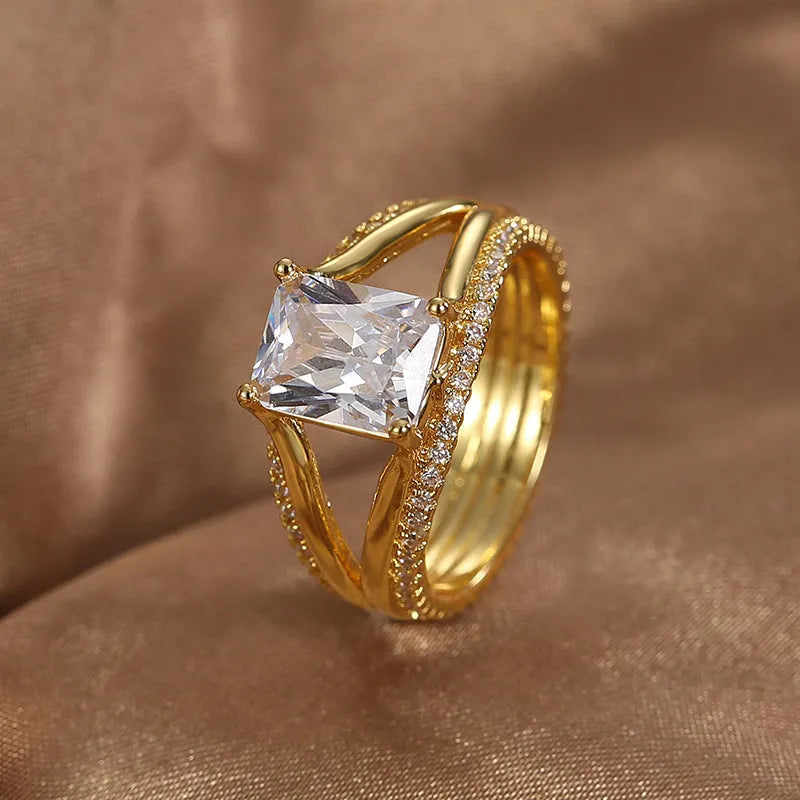 Gold electroplated copper ring with square zircon stone in geometric design, showing side profile