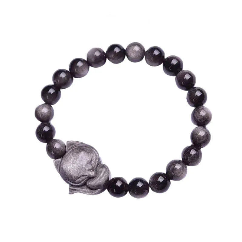 Close-up of black obsidian fox charm bracelet with 8mm polished bead on adjustable cord.