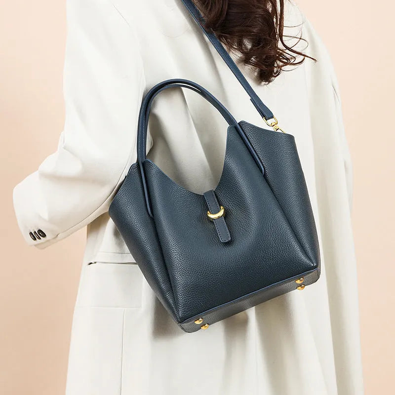 Genuine leather retro bucket handbag for women in beige, showing sewn thread detail and handheld straps.
