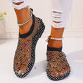 Women's flat mesh sandals with colourful rhinestone decoration on the upper and a round toe.