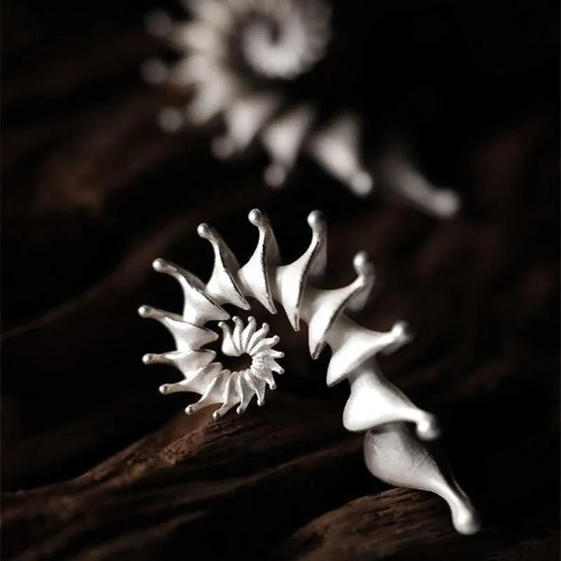 Matte finish conch stud earrings with exaggerated three-dimensional alloy design