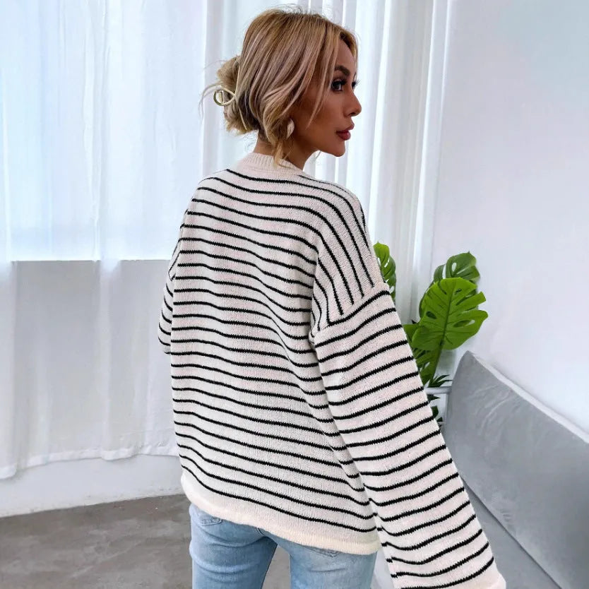 Black and white striped women's loose top with drop-shoulder sleeves and button detail