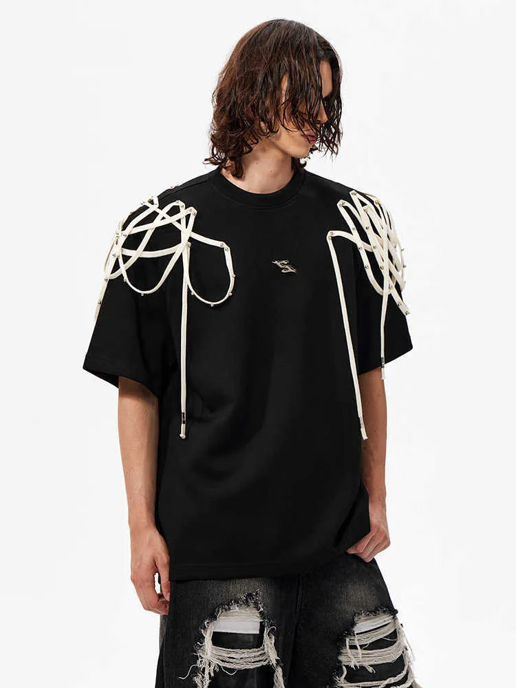 Black loose fit T-shirt with padded shoulder detail and rivet ribbon accent.