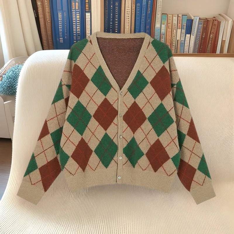Acrylic knitted cardigan coat in light khaki colour, shown on a hanger.