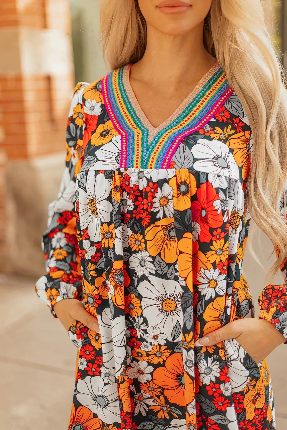Orange floral print striped lace V-neck long sleeve mini dress on hanger
