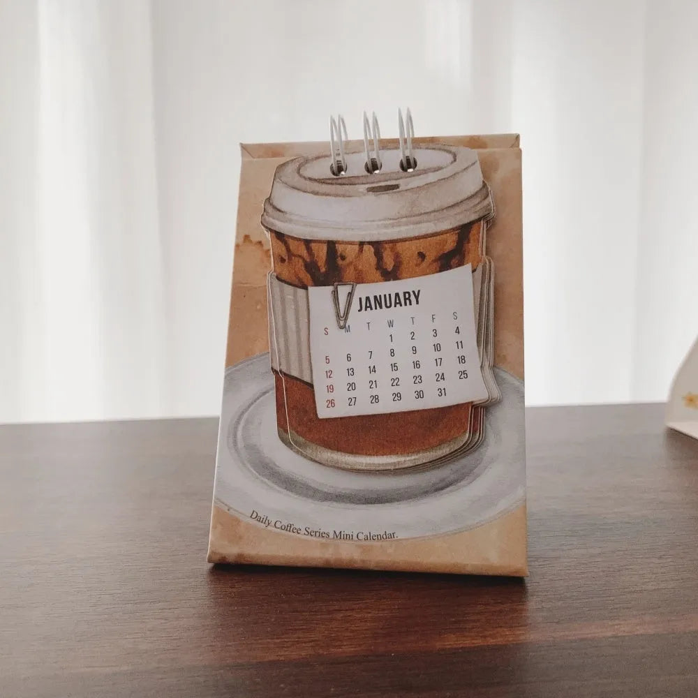 Mini coffee desk calendar 2025 with four design options on small desk surface