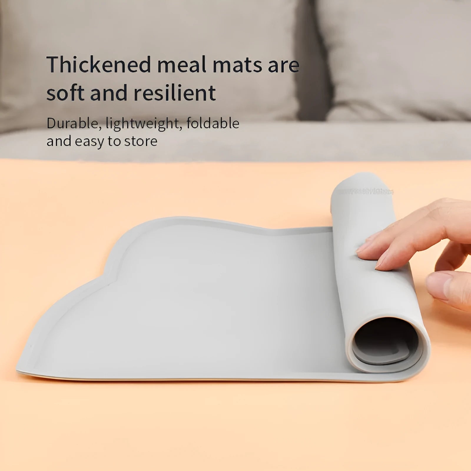 Blue silicone pet feeding mat for dog or cat bowls on a wooden floor.
