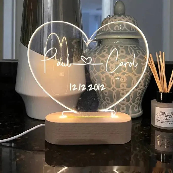 Custom acrylic LED night light displaying personal names and date, 20cm by 11.5cm, with USB cable.