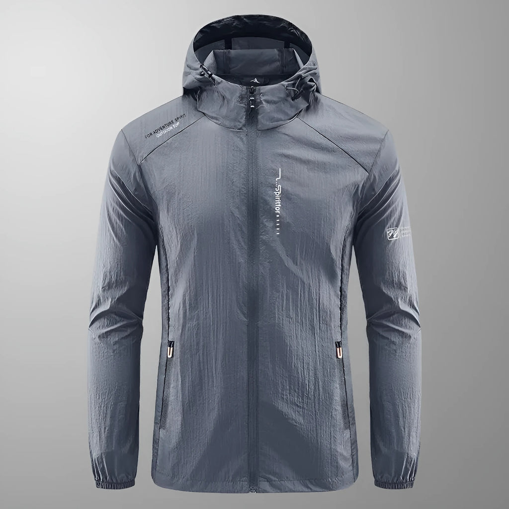 Man wearing a loose-fit light grey hooded nylon jacket for summer sun protection.
