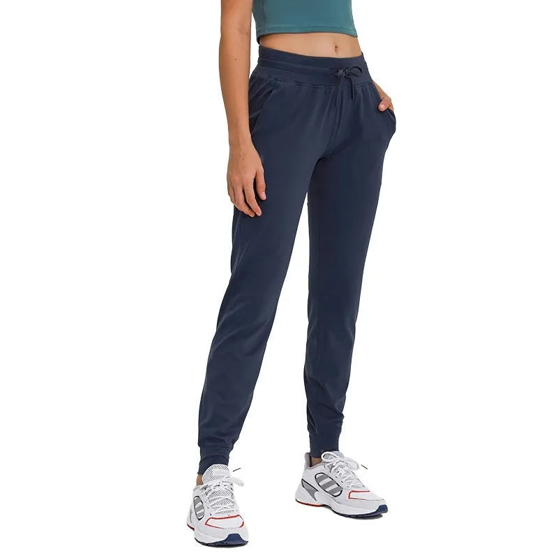 Women's high waist yoga pants with a drawstring waistband in a khaki colour.
