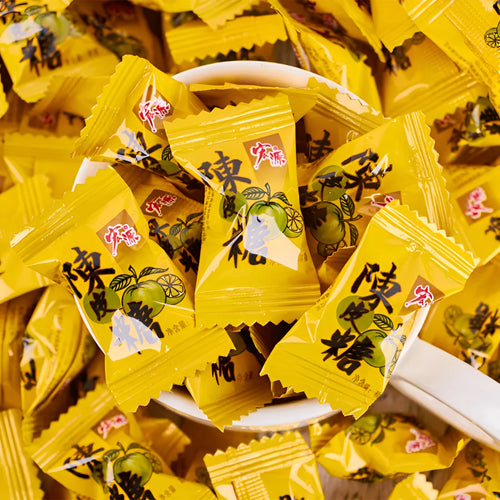 Three bags of Asian fruit hard candy: plum sugar, guava, and tangerine peel varieties with weight labels