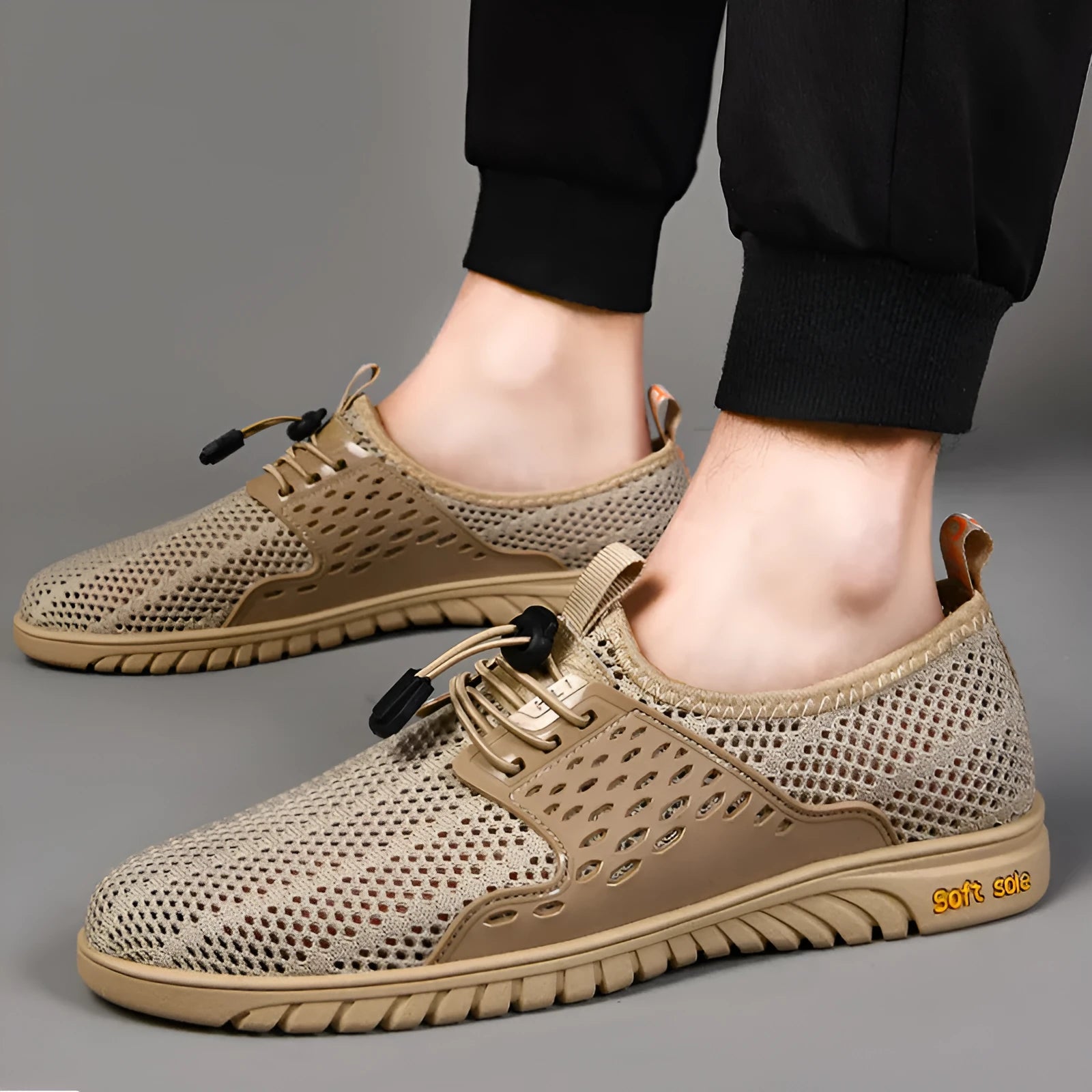Men's black casual shoes with breathable mesh upper and elastic band closure on a white background.