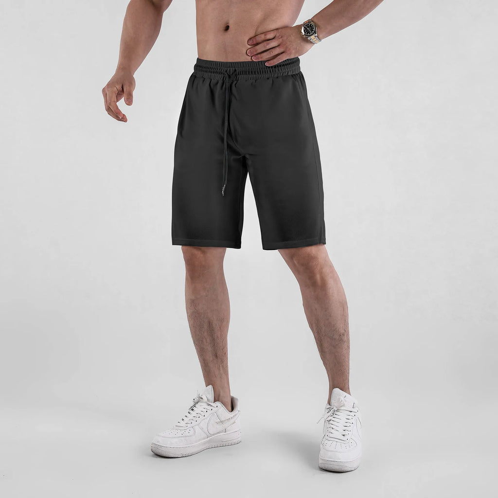 Man wearing loose black quick-drying capri pants for casual summer wear.