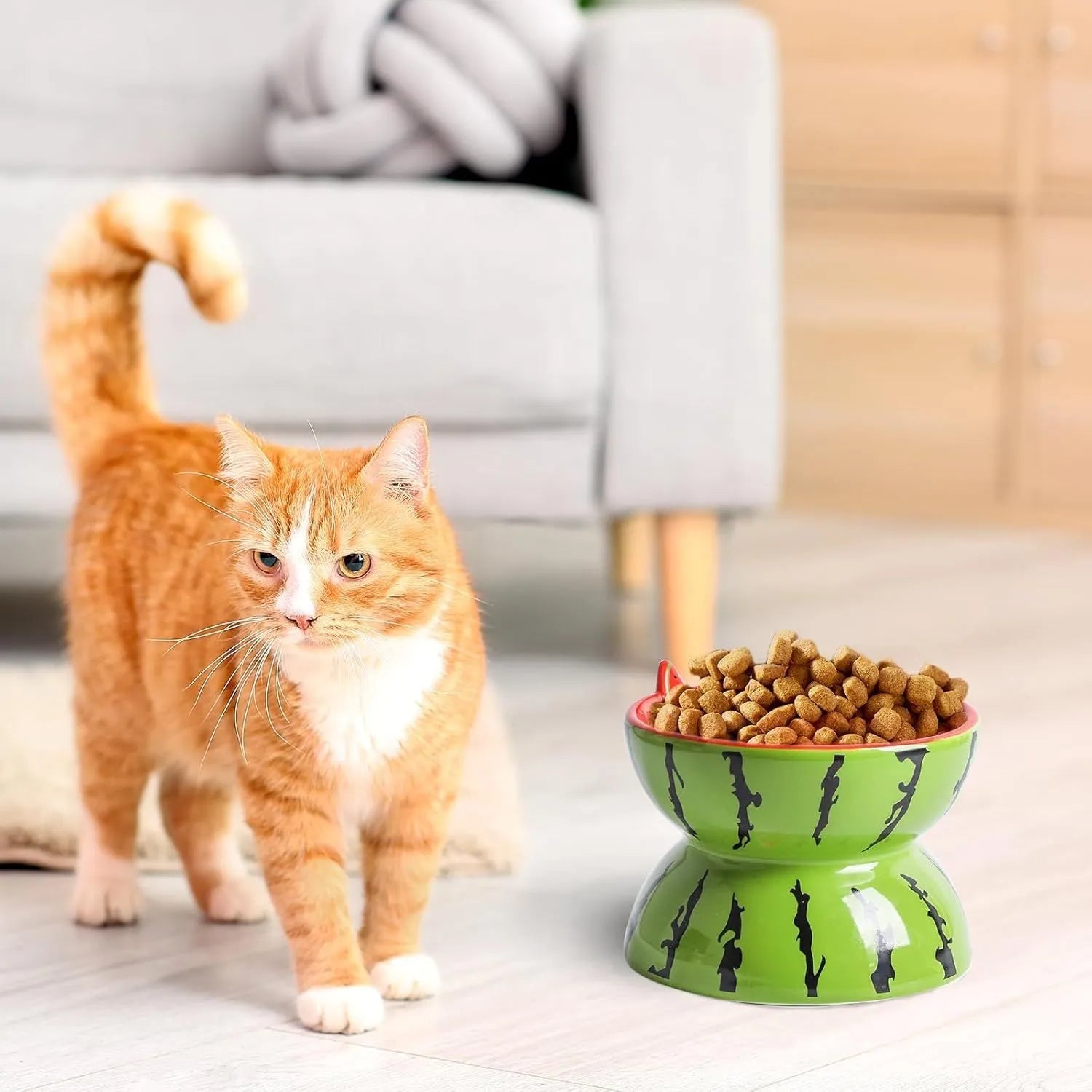 Ceramic raised cat bowl in orange pattern, showing tilted wide-rim design on elevated stand.